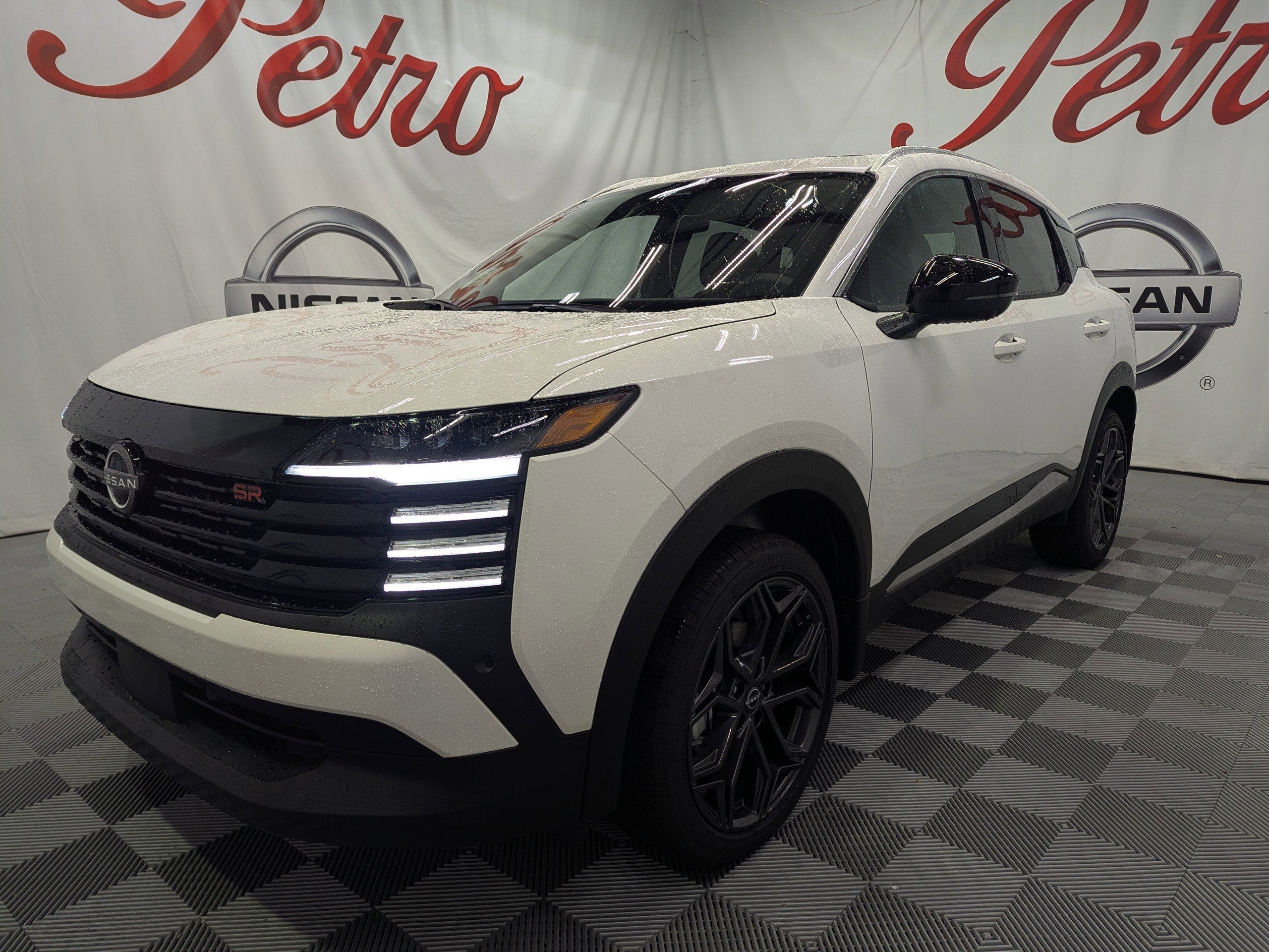 2026 Nissan Kicks SR in Aspen White Tricoat — front three-quarter view